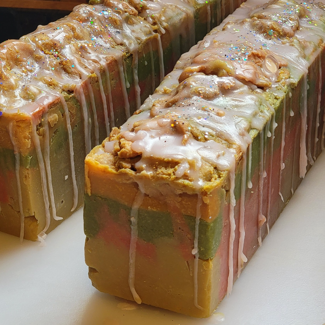 Three rectangular pieces of soap with a colorful pattern on a white surface.