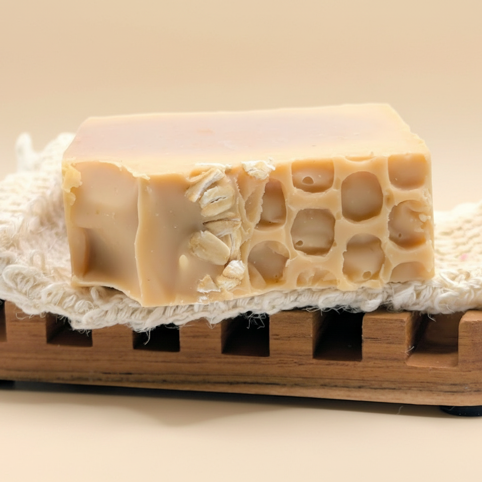 Bar of soap with a honeycomb texture on a wooden soap dish with a white background