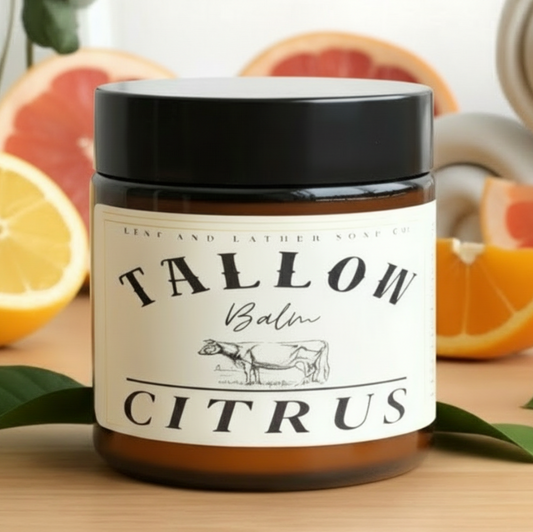 Jar of Tallow Balm Citrus with citrus fruits in the background
