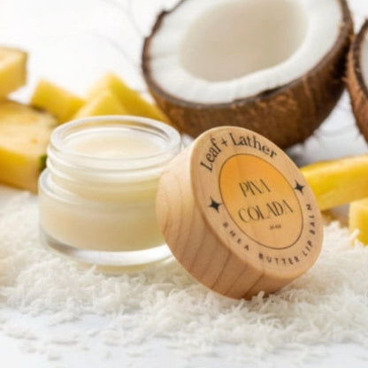 Jar of Pina Colada body butter with coconuts and mangoes on a white background