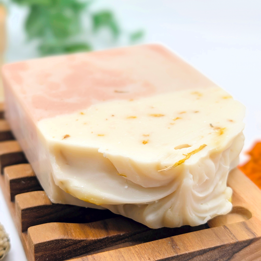 Block of cheese on a wooden cutting board with a blurred background